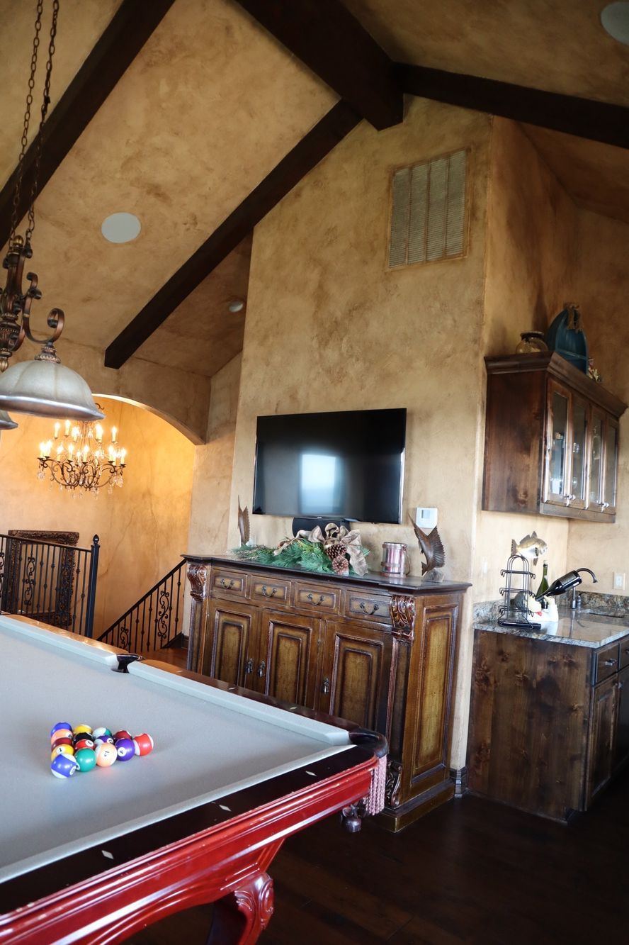 a pool table in a living room with a flat screen tv