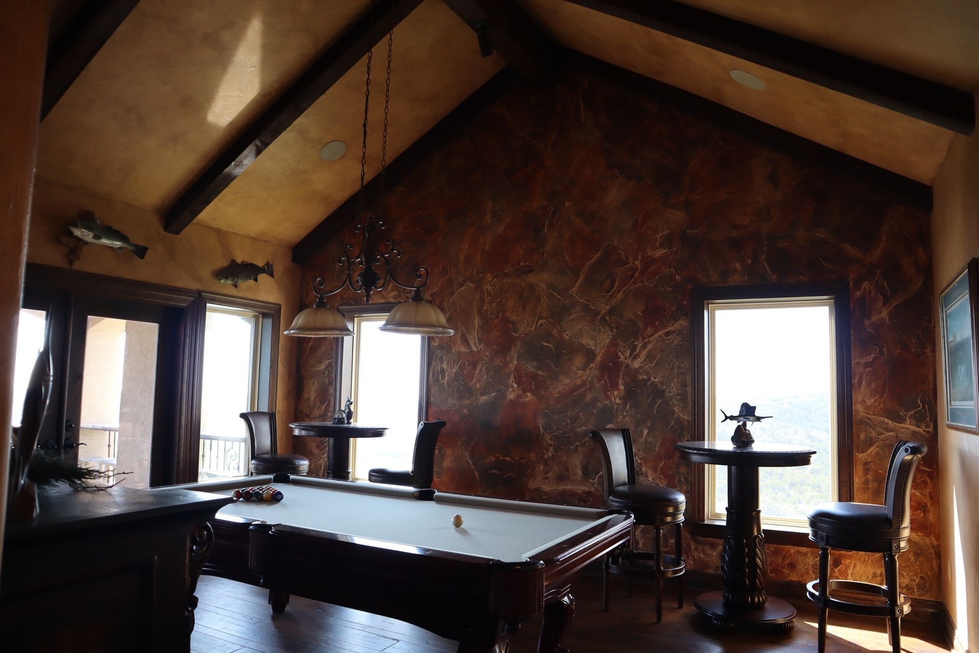 a pool table in a room with a vaulted ceiling