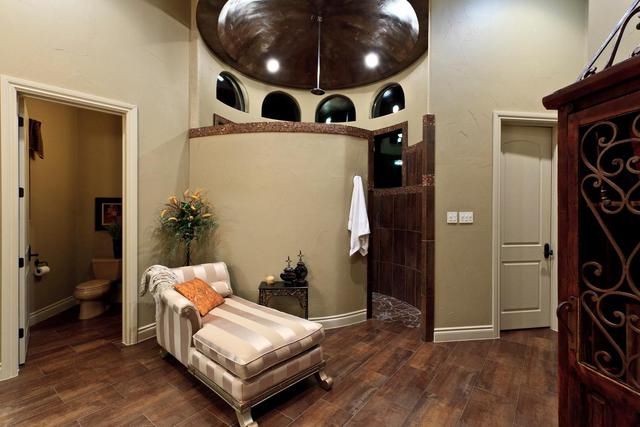 A living room with a chaise lounge and a toilet