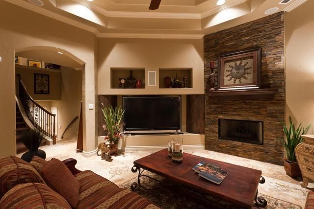 A living room with a fireplace and a flat screen tv