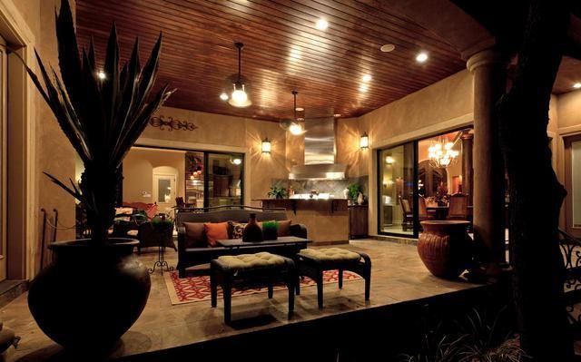 A living room with a wooden ceiling and lots of furniture