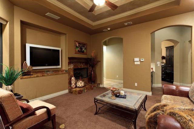 A living room with a fireplace and a flat screen tv