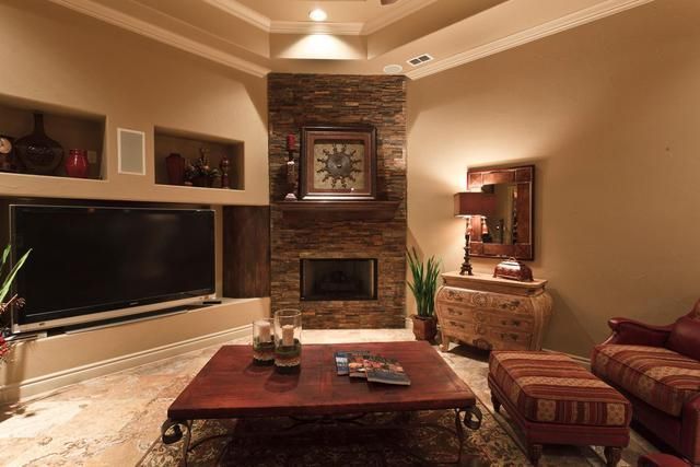 A living room with a fireplace and a flat screen tv