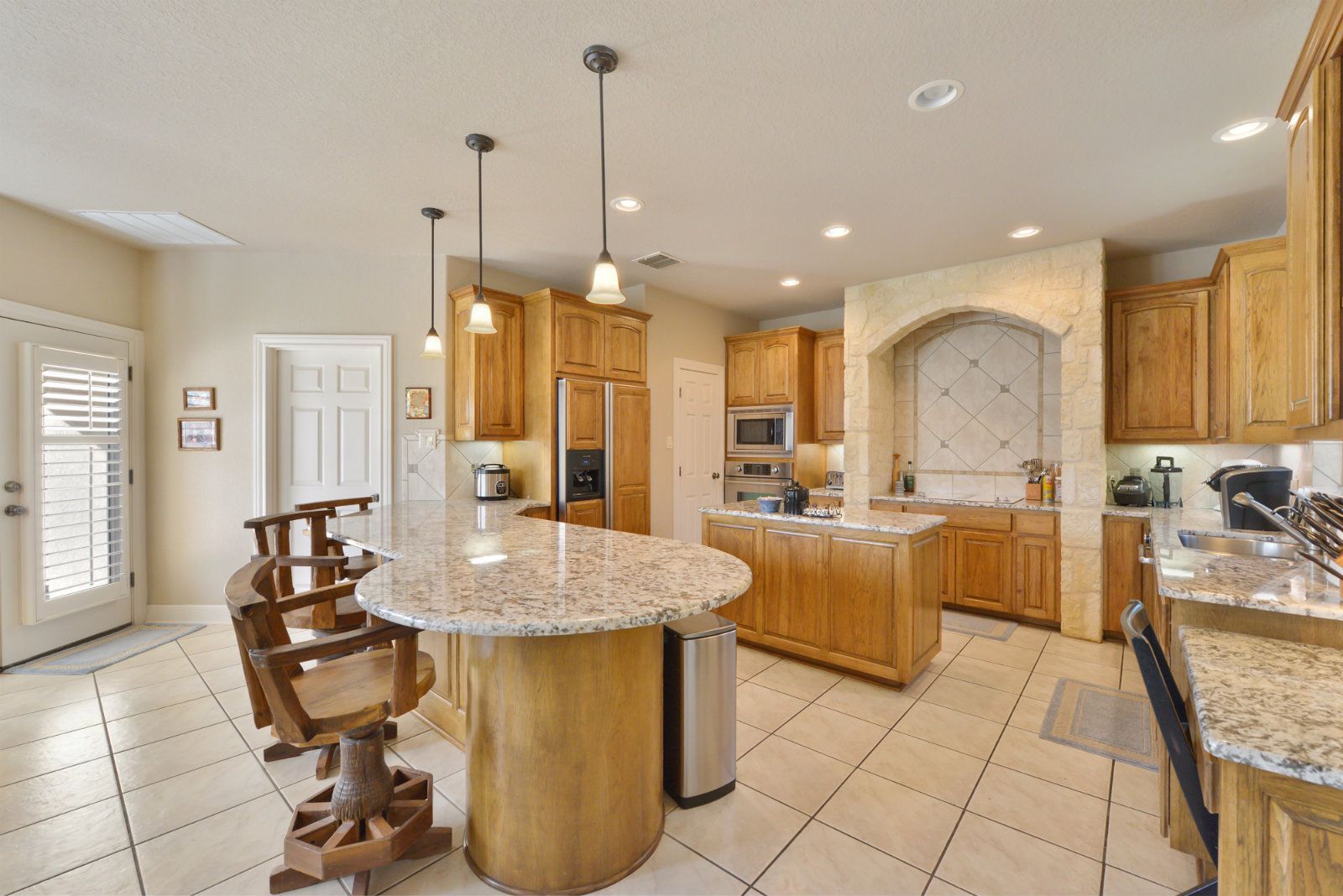 A kitchen with a large island in the middle of it