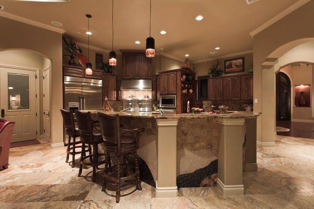 A kitchen with stainless steel appliances and a large island
