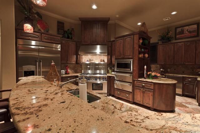 A kitchen with granite counter tops and stainless steel appliances