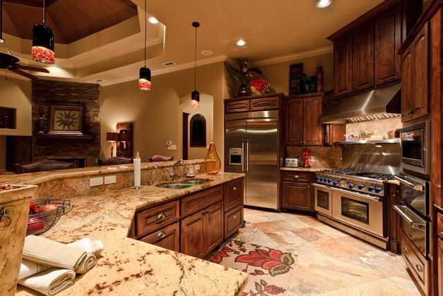 A kitchen with stainless steel appliances and wooden cabinets