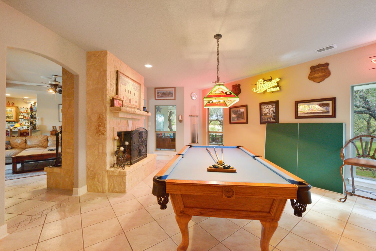 There is a pool table in the middle of the room