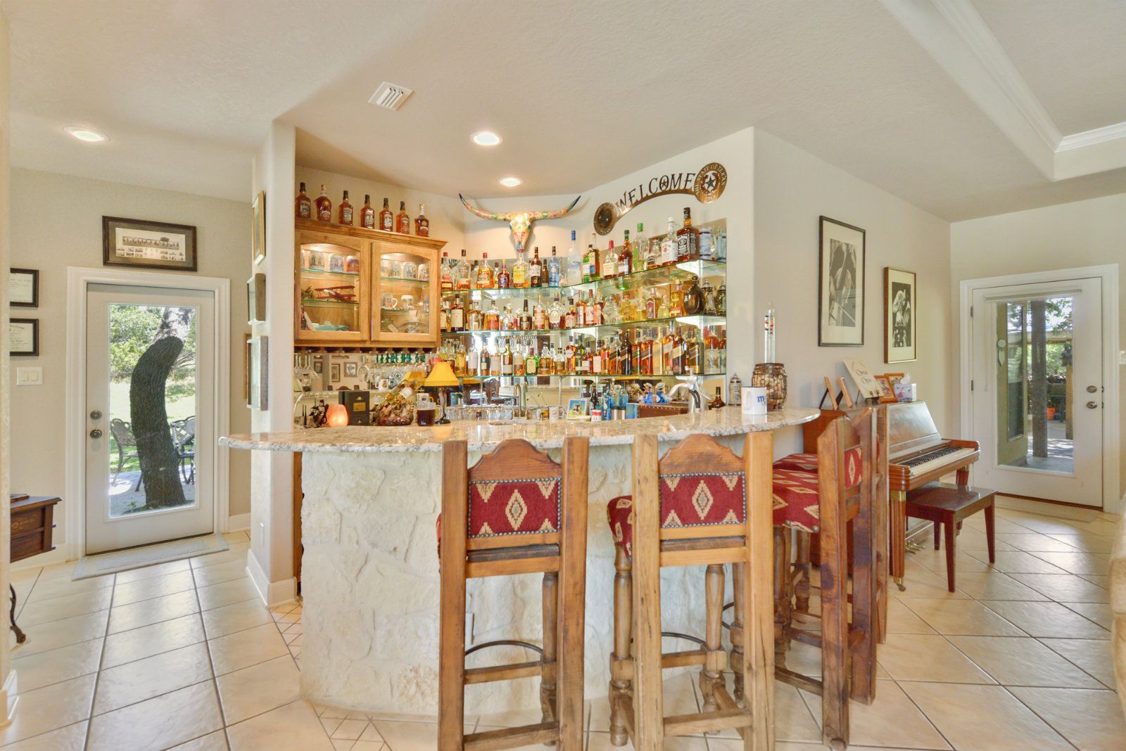 A kitchen with a bar and stools in it