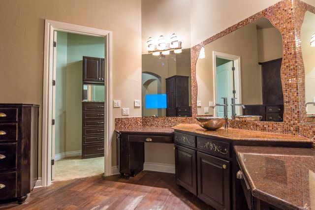 A bathroom with two sinks and a large mirror