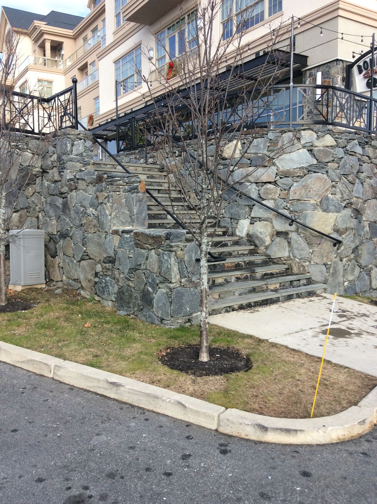 a stone wall with stairs leading up to a building