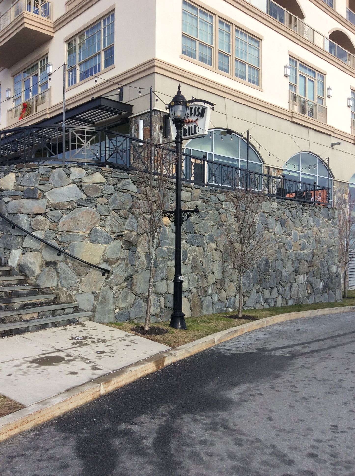 a building with a stone wall and stairs leading up to it