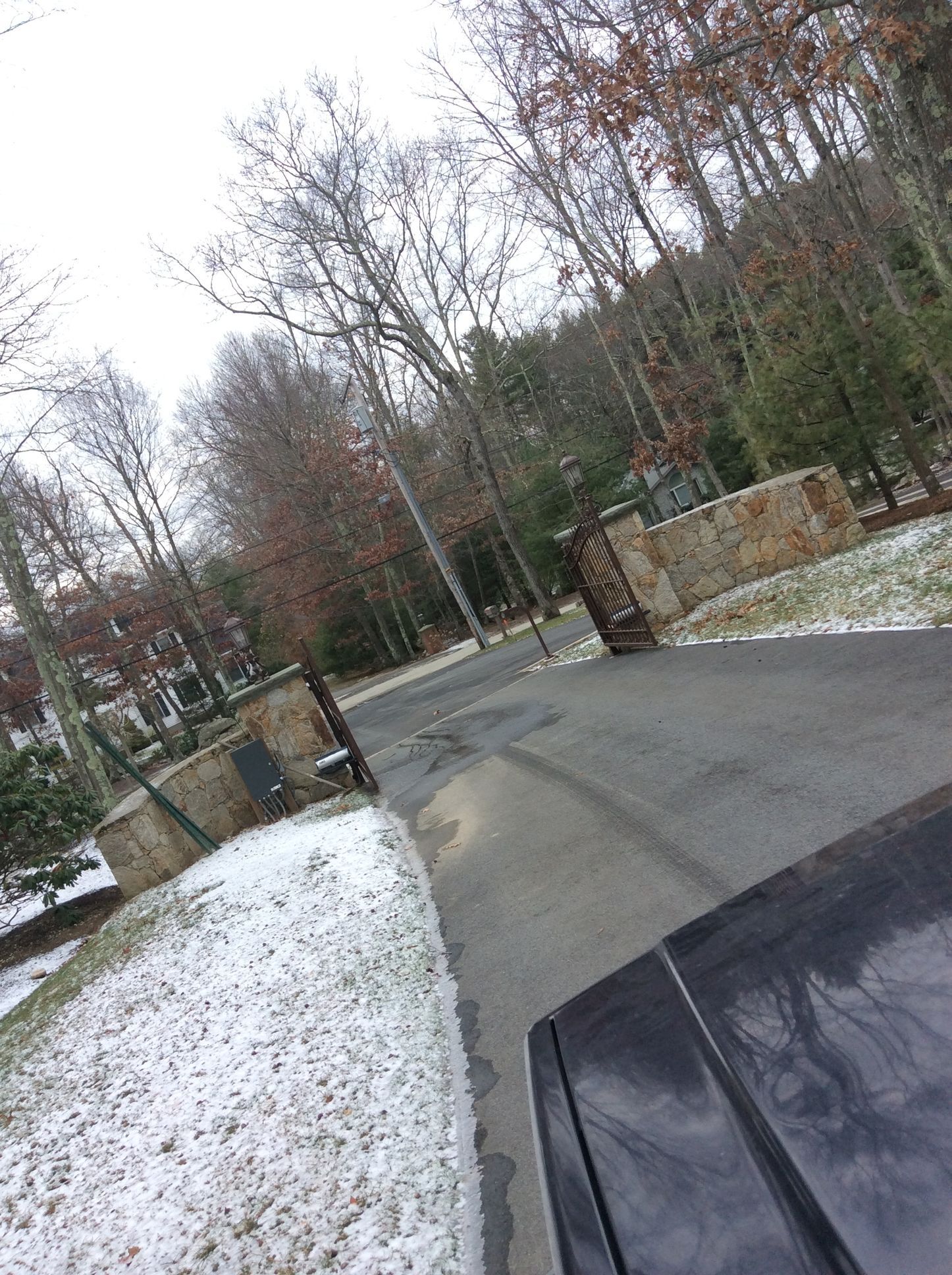a black car is parked on the side of a snowy road
