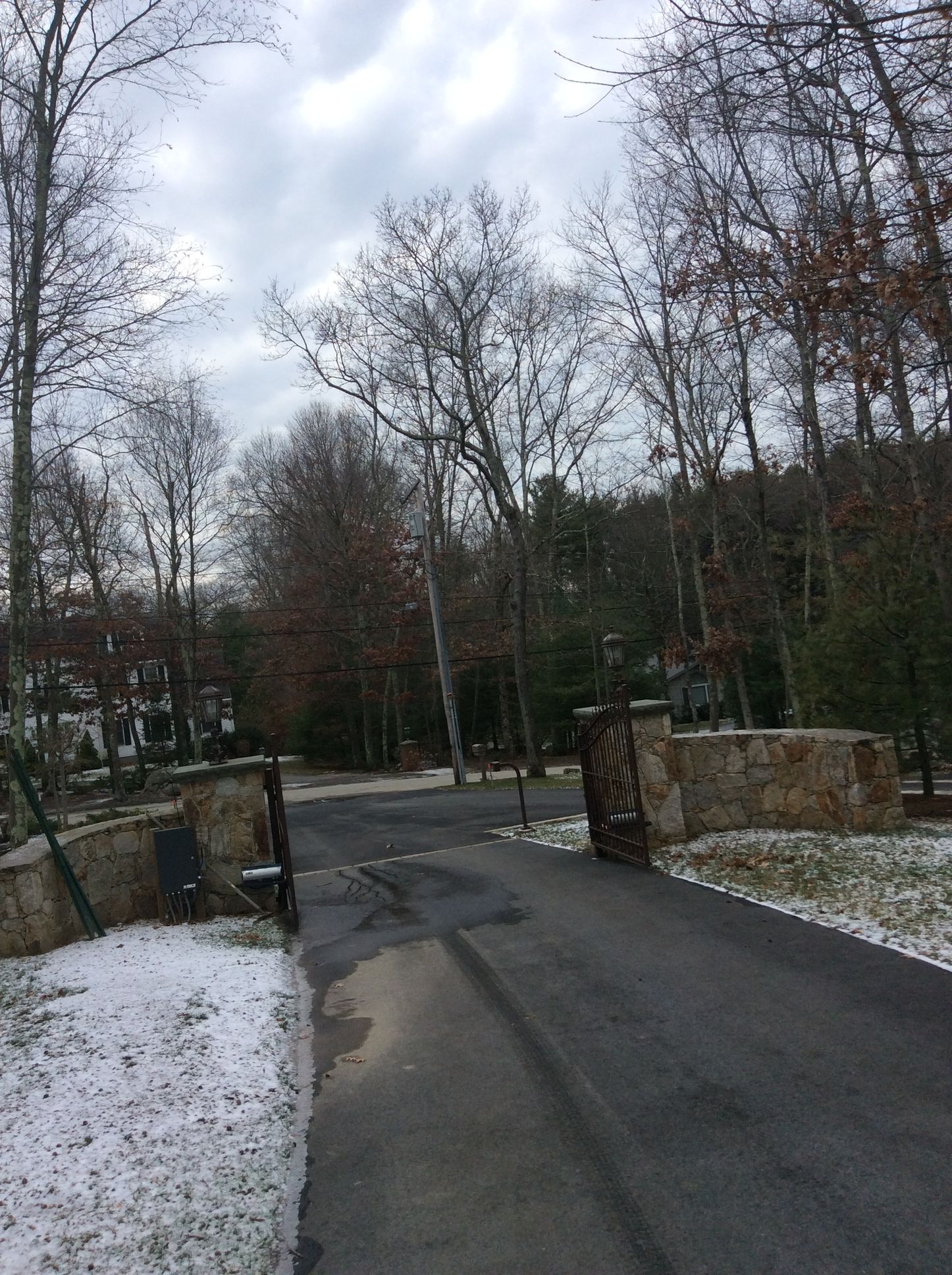 a road with snow on the ground and trees on the side