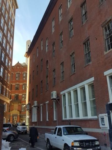 a white truck is parked in front of a large brick building