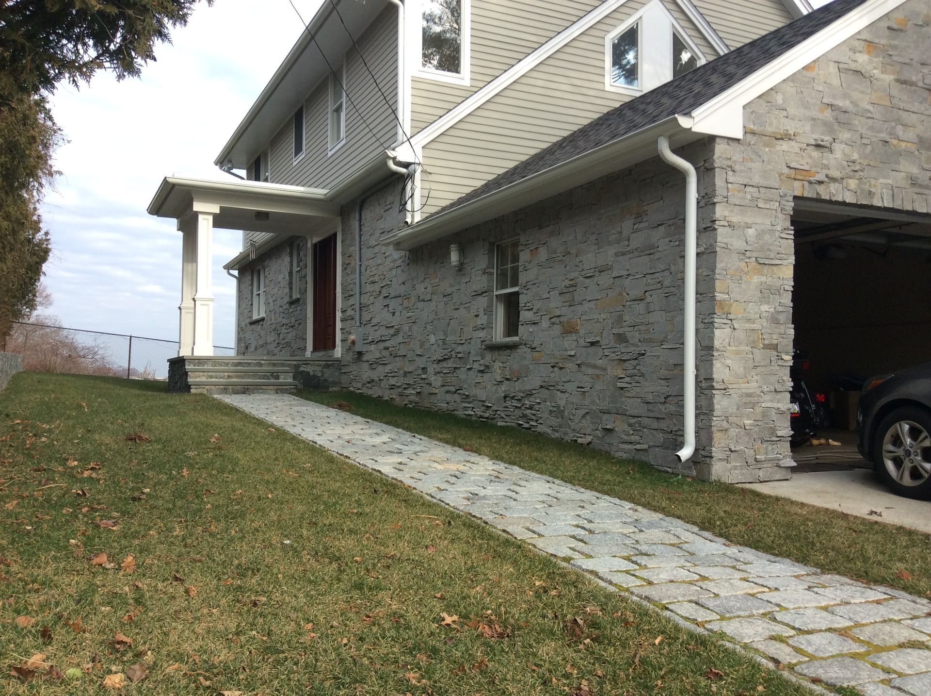 a car is parked in a garage next to a house