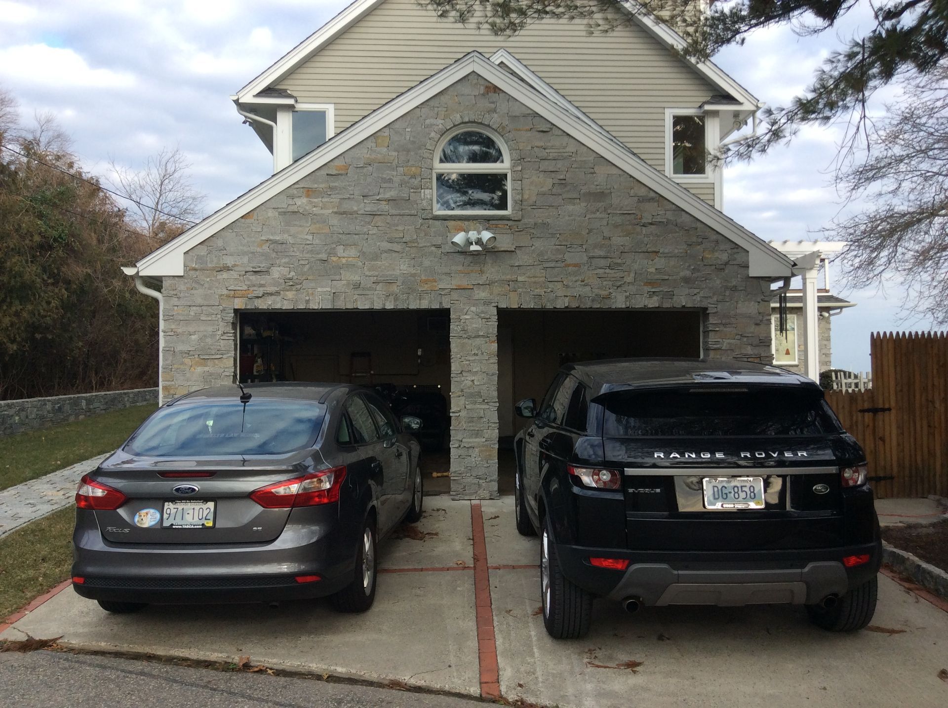 two cars are parked in front of a garage