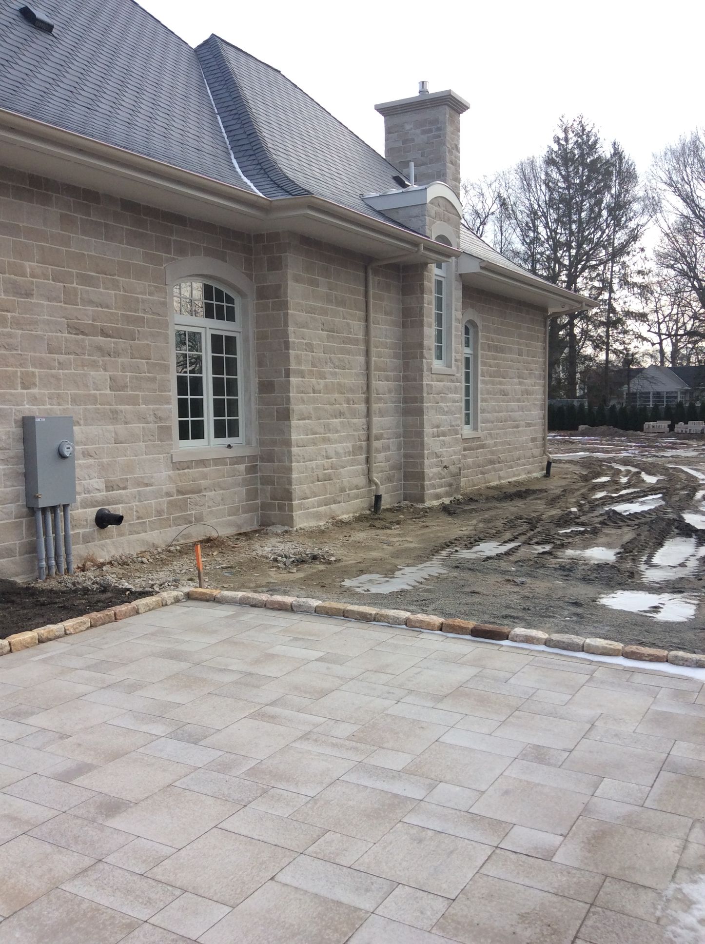 a brick house with a patio in front of it