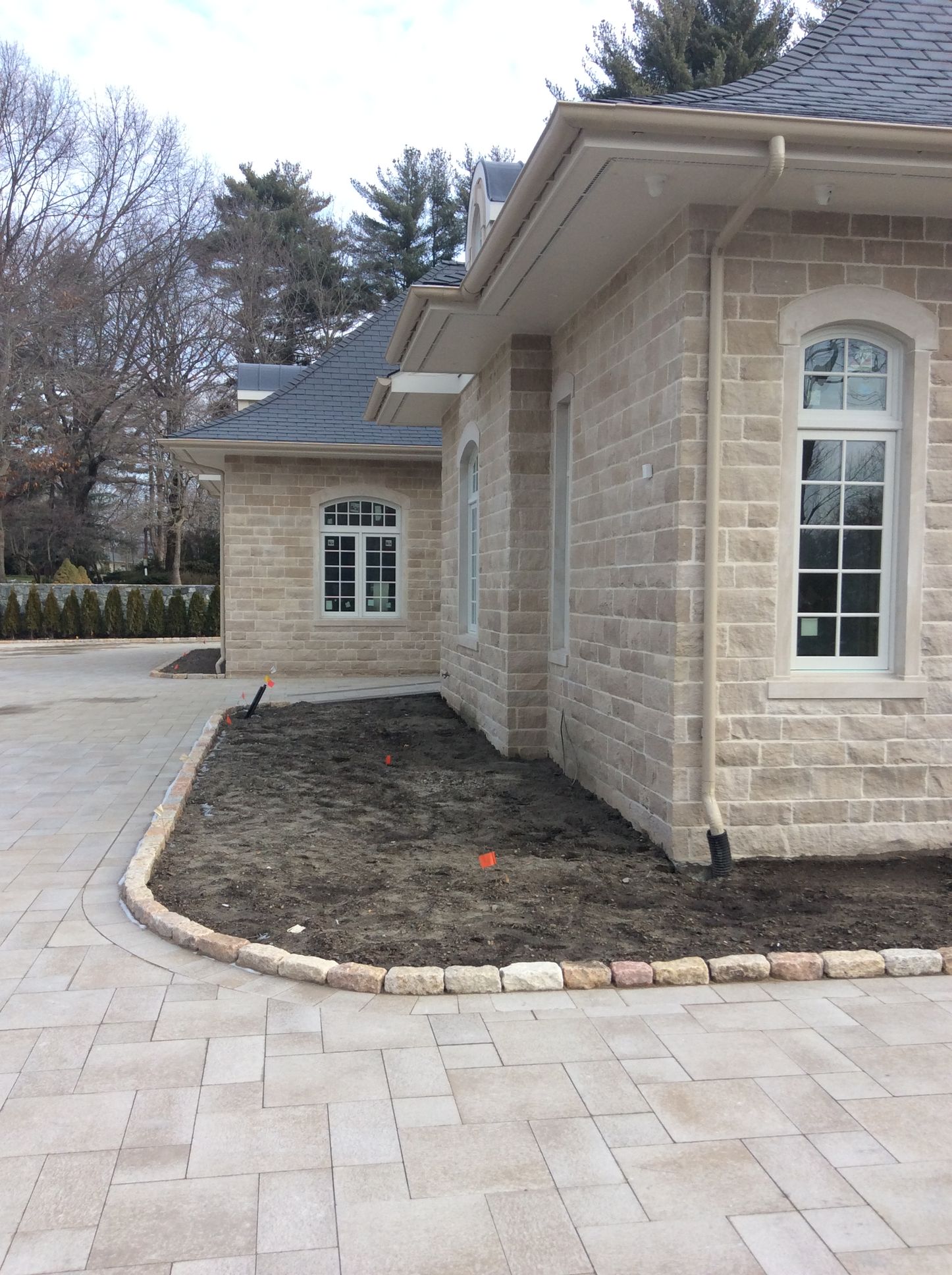 a brick house with a driveway in front of it