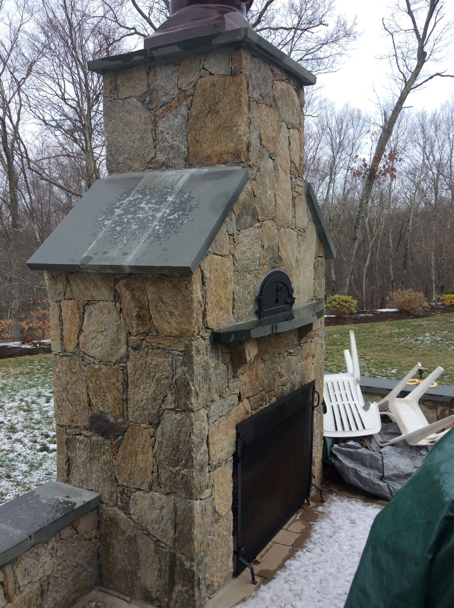 a large stone fireplace with a black door