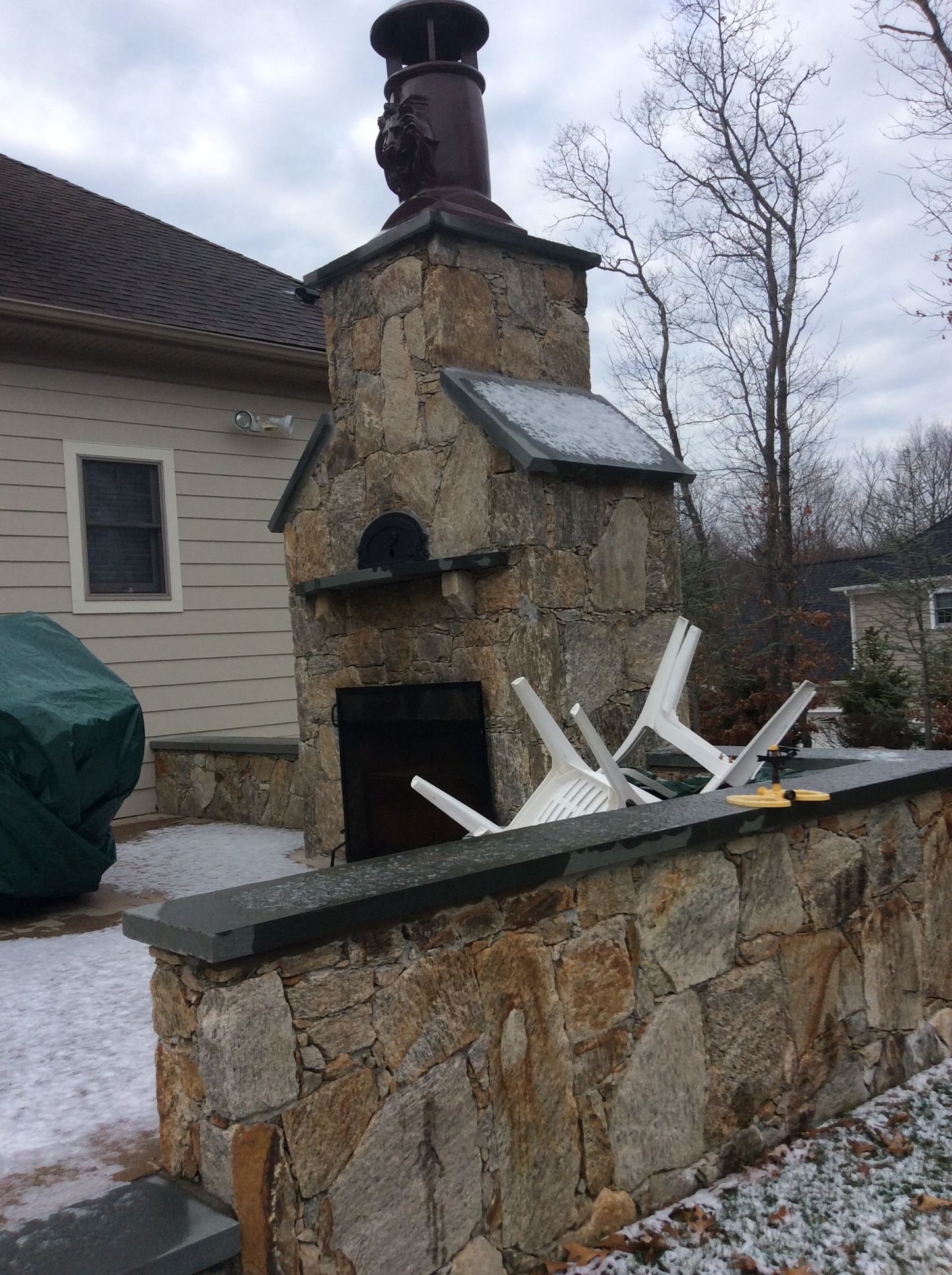a stone fireplace with a chimney on top of it