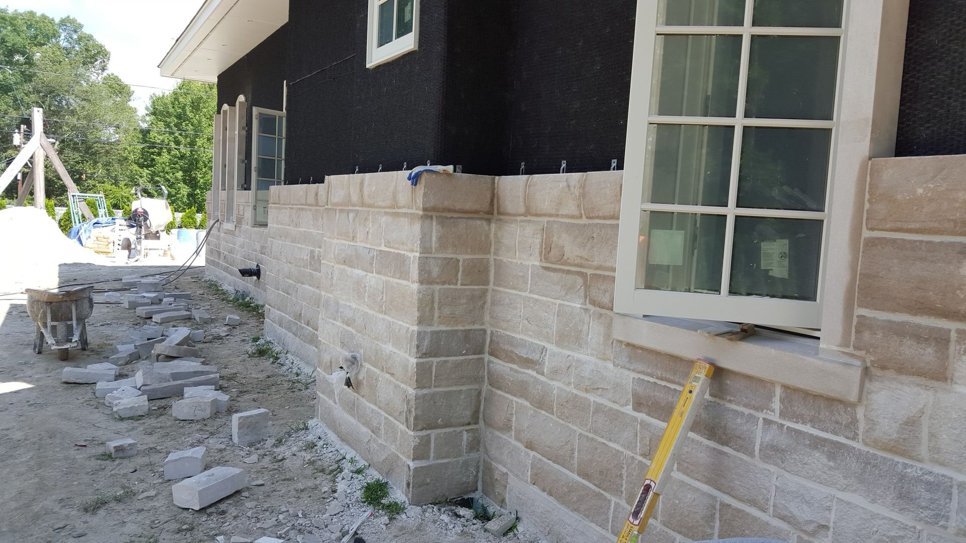 a brick wall is being built on the side of a house
