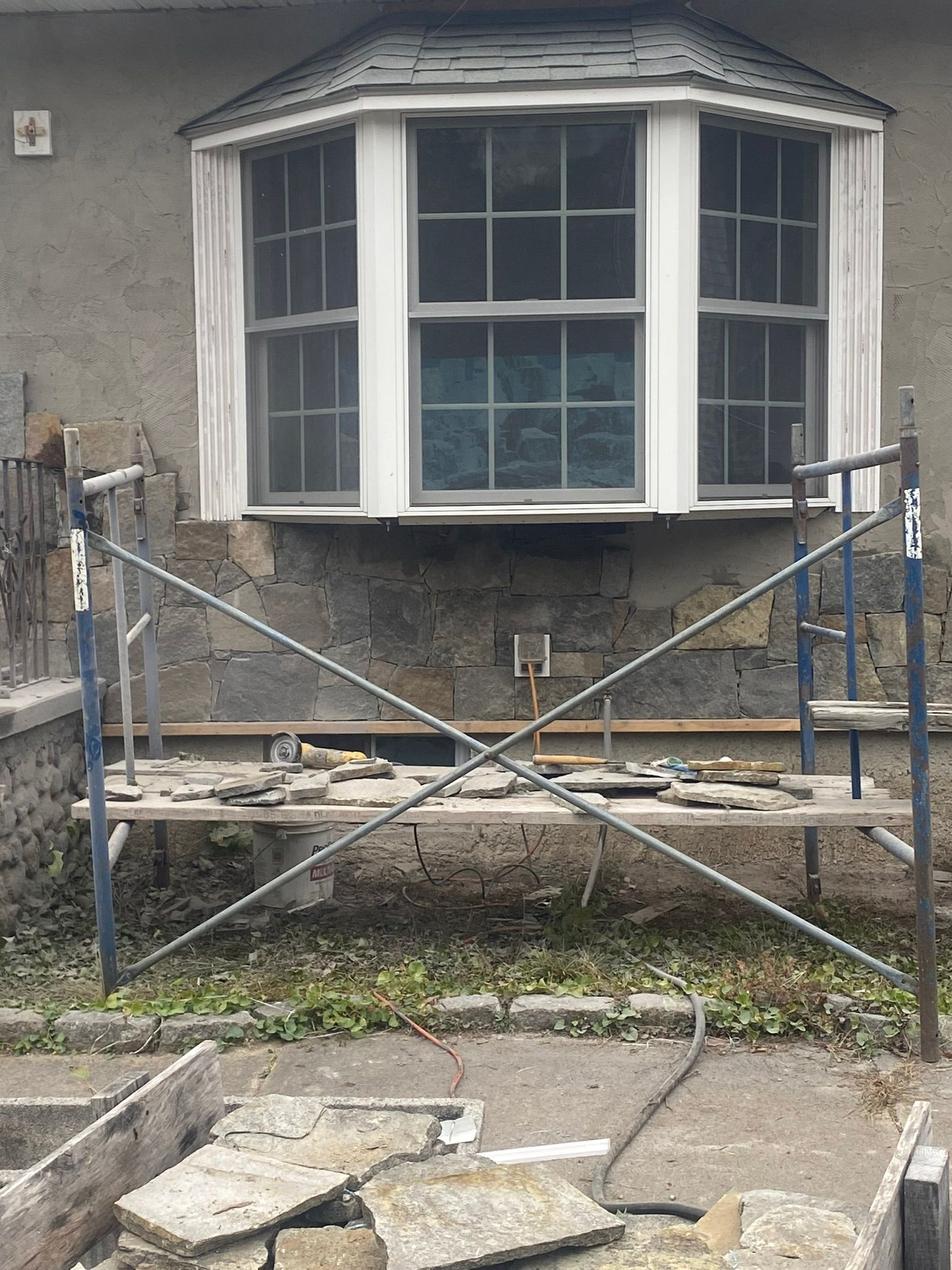 a house with a bay window and a scaffolding in front of it
