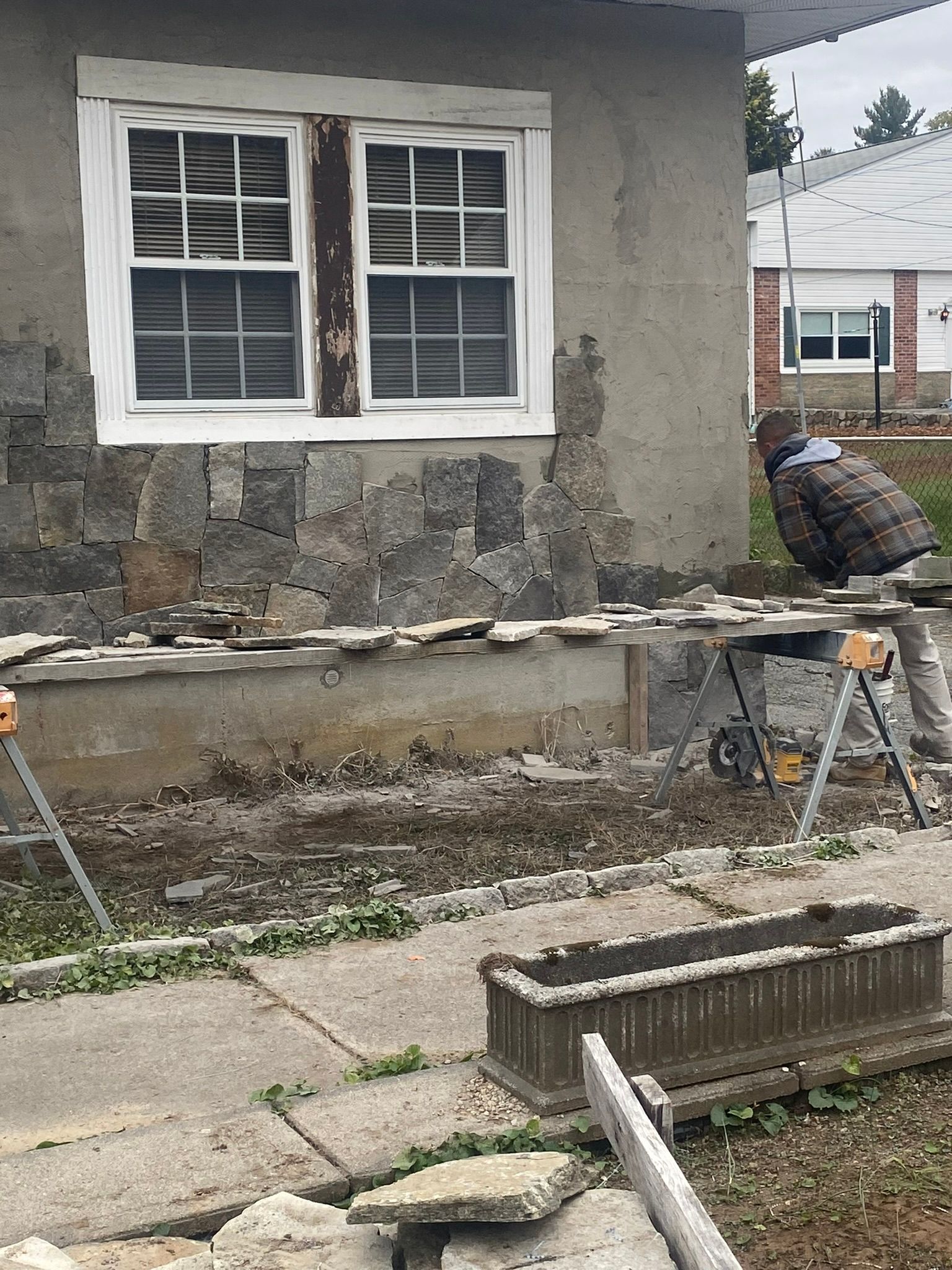 a man is working on the side of a house