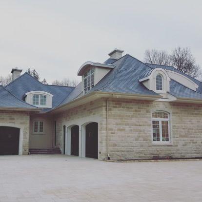 a large brick house with a blue roof