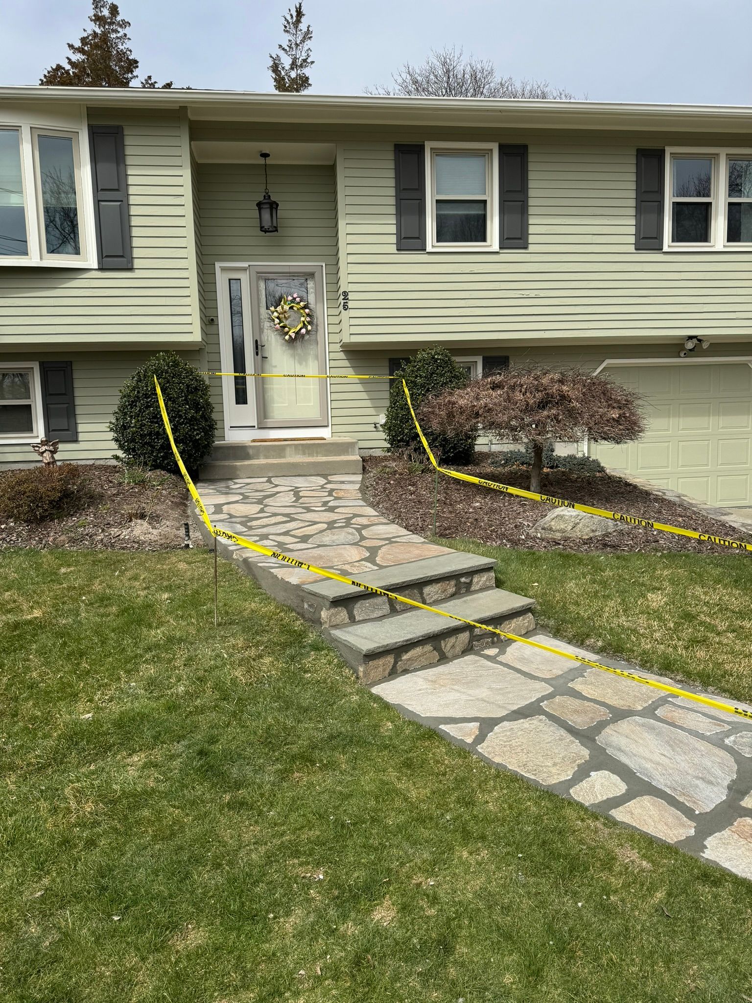 A house with a stone walkway leading to the front door