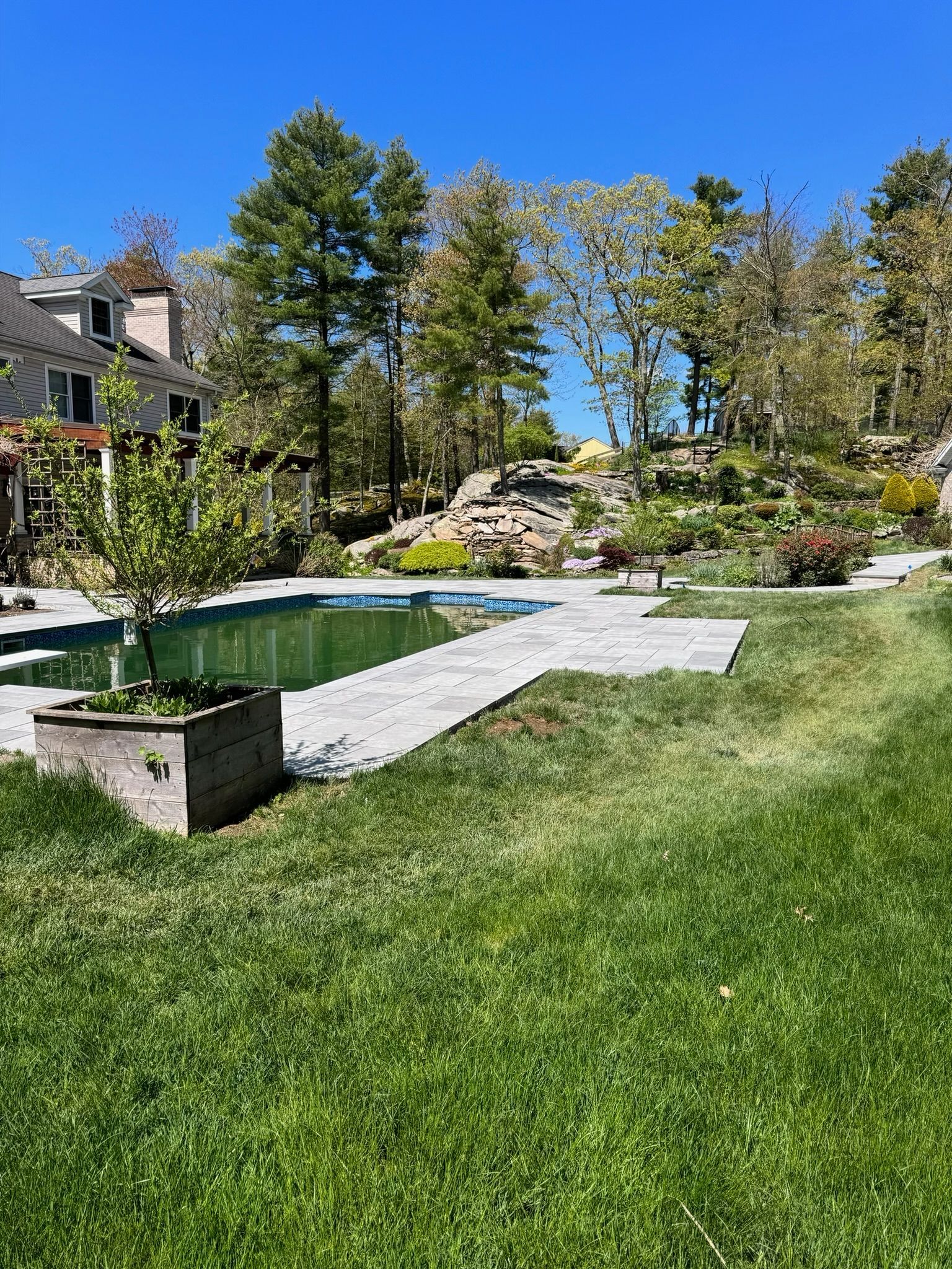 There is a large swimming pool in the middle of the yard