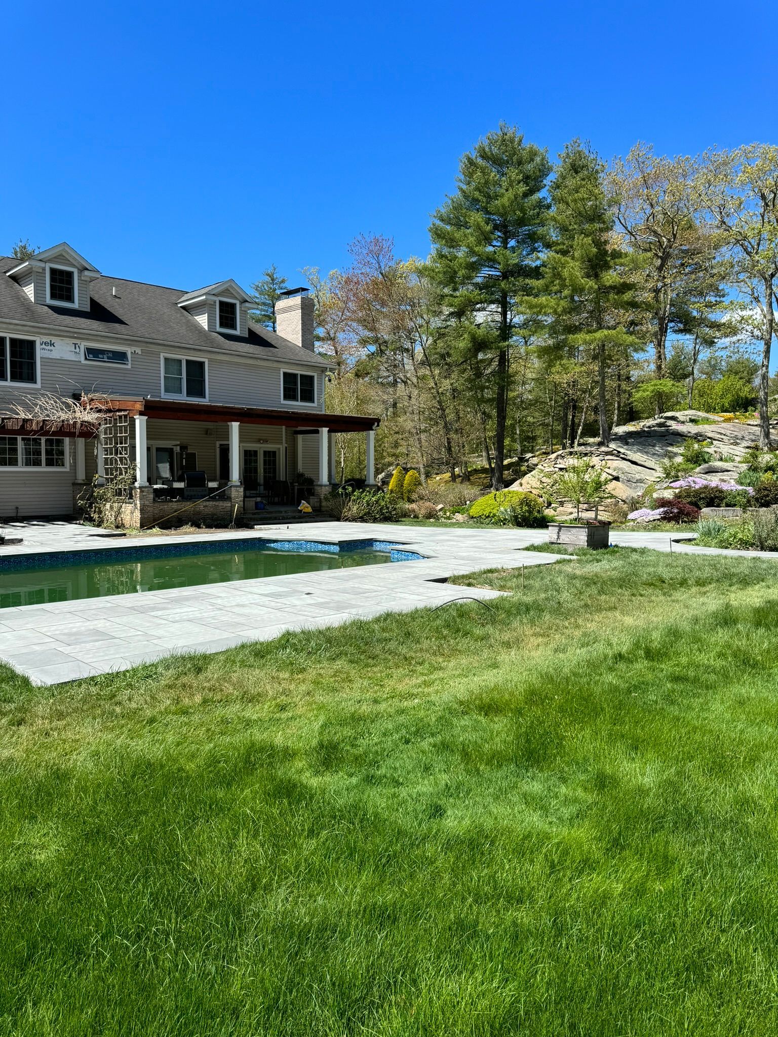 A large house with a large swimming pool in the backyard