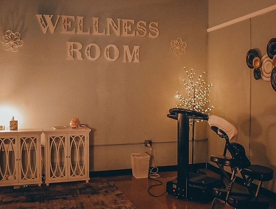 Wellness room with a massage chair, cabinet, and decorative lights.
