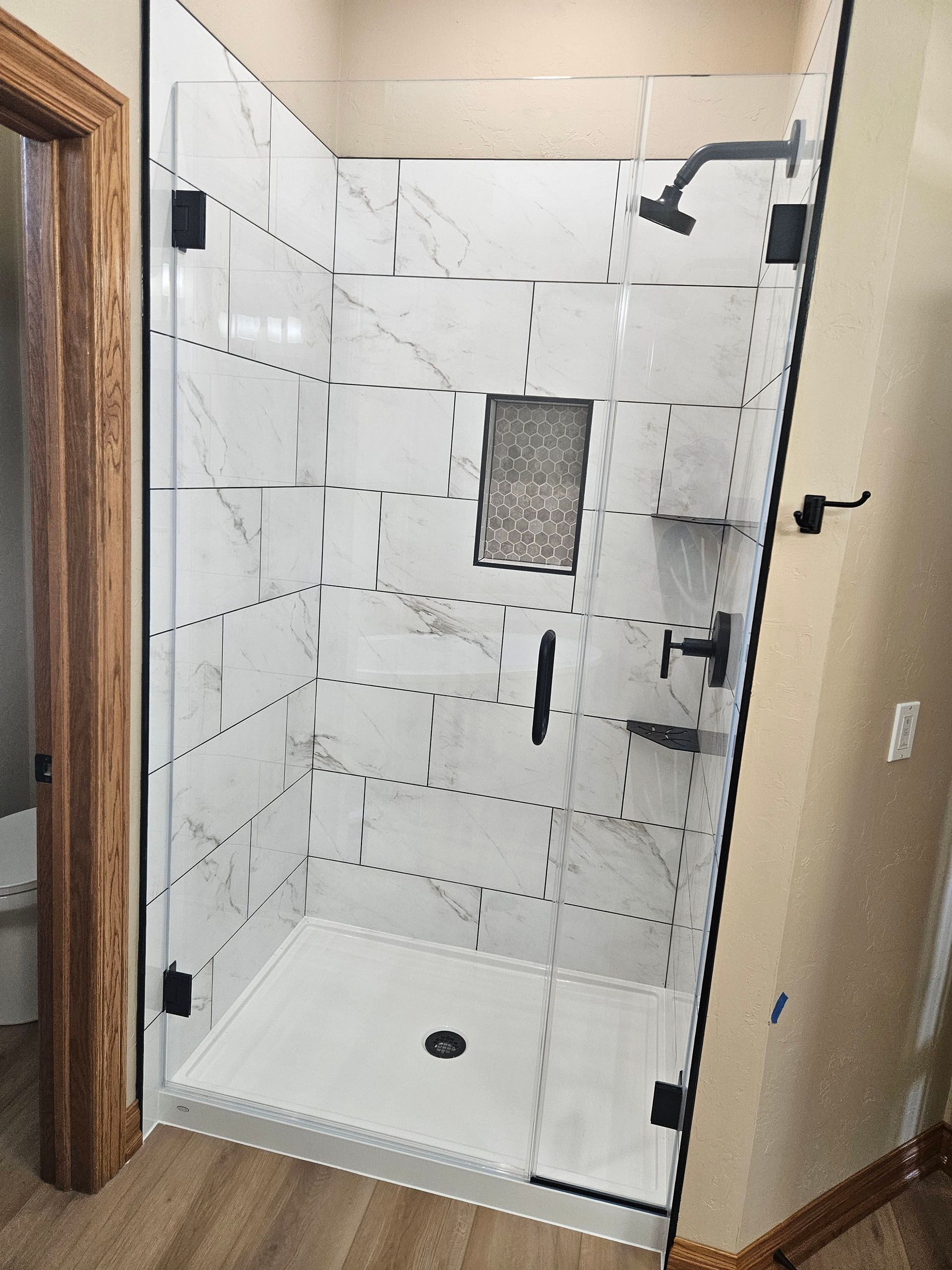 Door and panel - A bathroom with a sink, shower, and mirror.
