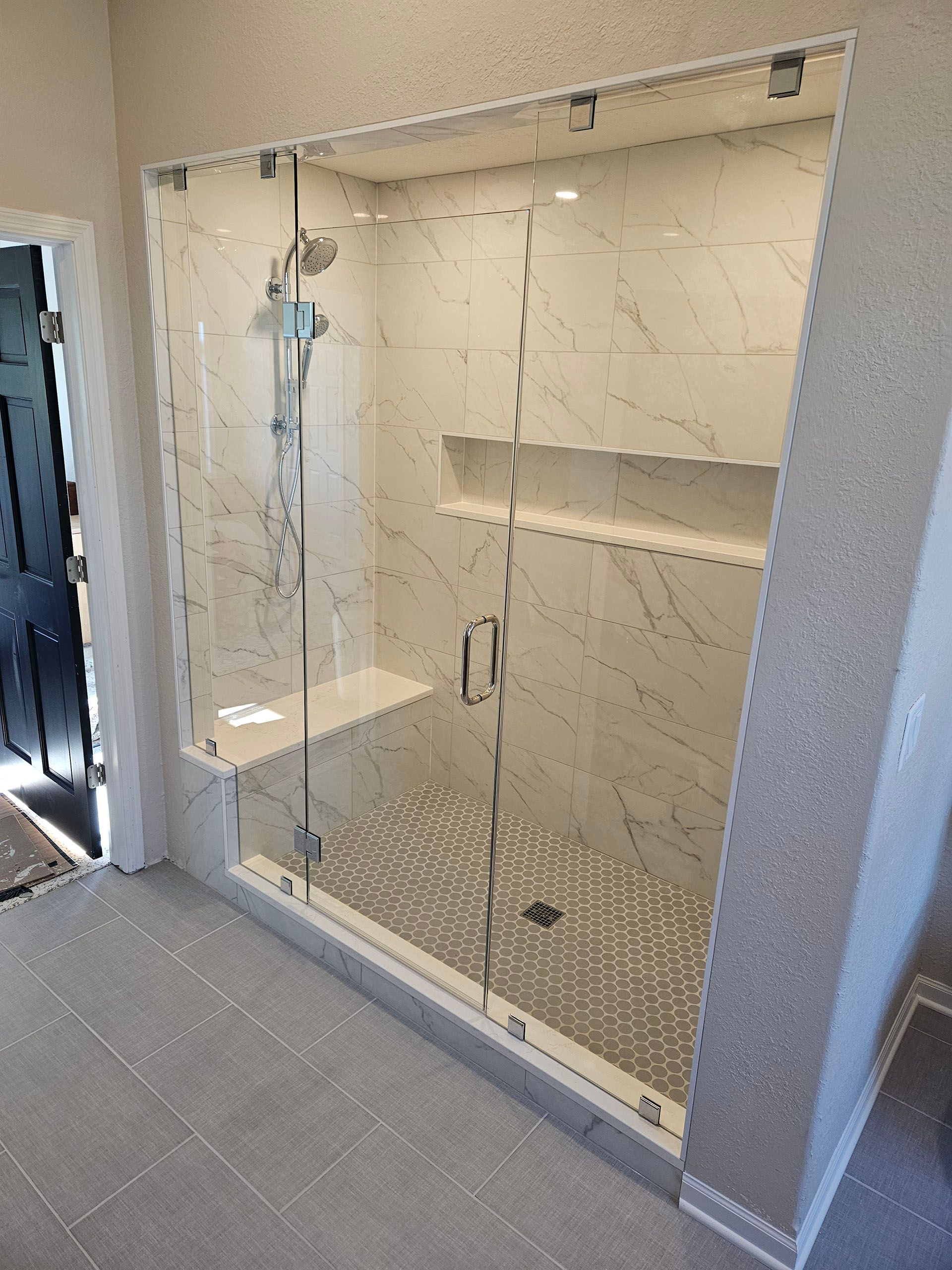 Multiple panels - A bathroom with a walk in shower with a glass door.