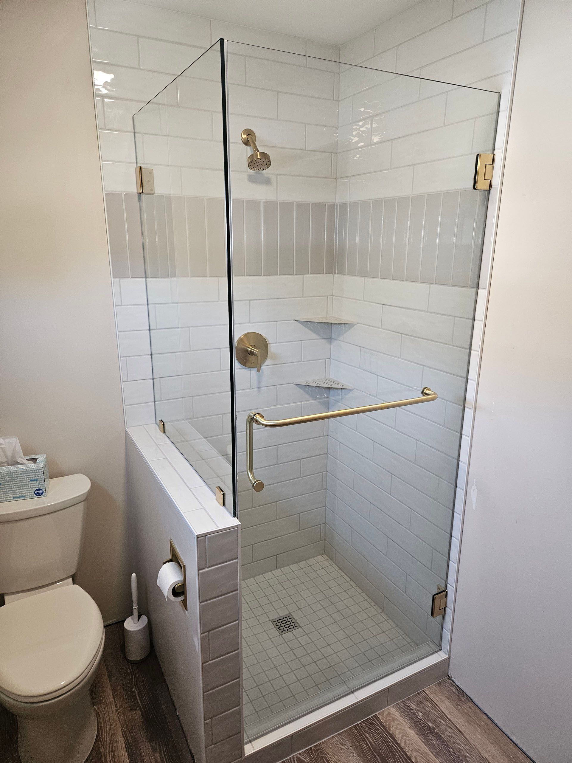 Return panel - A bathroom with a walk in shower and a sink.