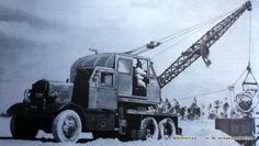 A black and white photo of a truck with a crane attached to it.