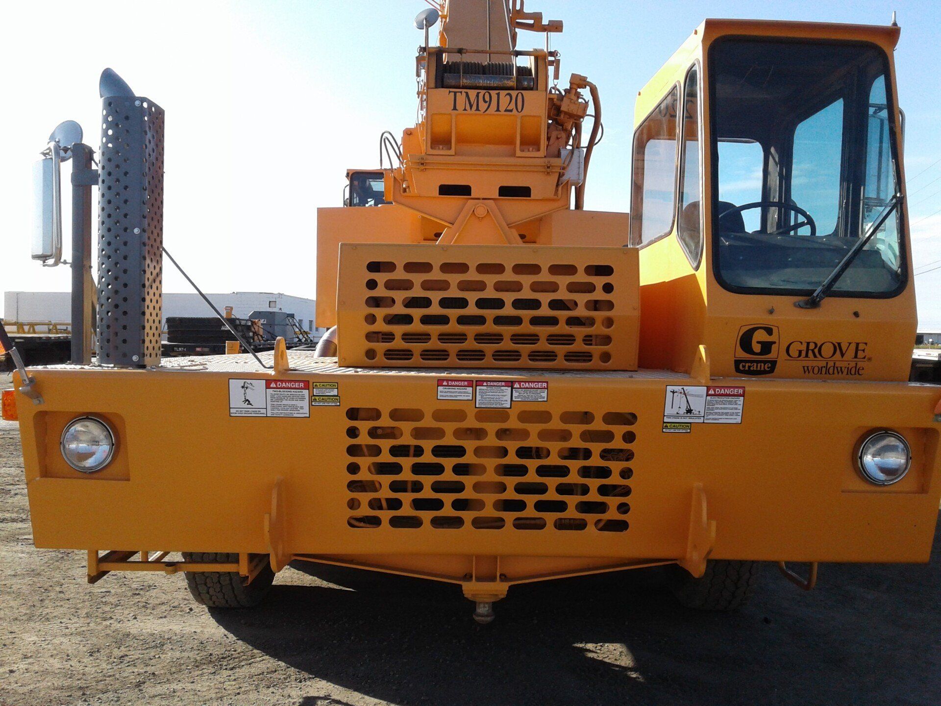 A yellow vehicle with the word grove on it