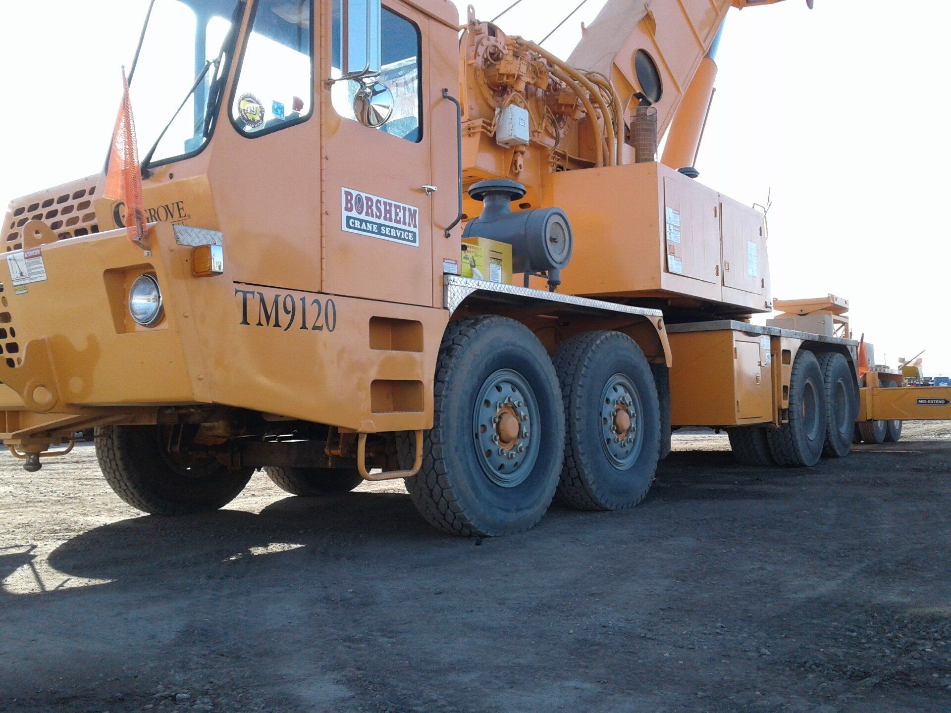 A large yellow truck with the numbers tm1913 on the side