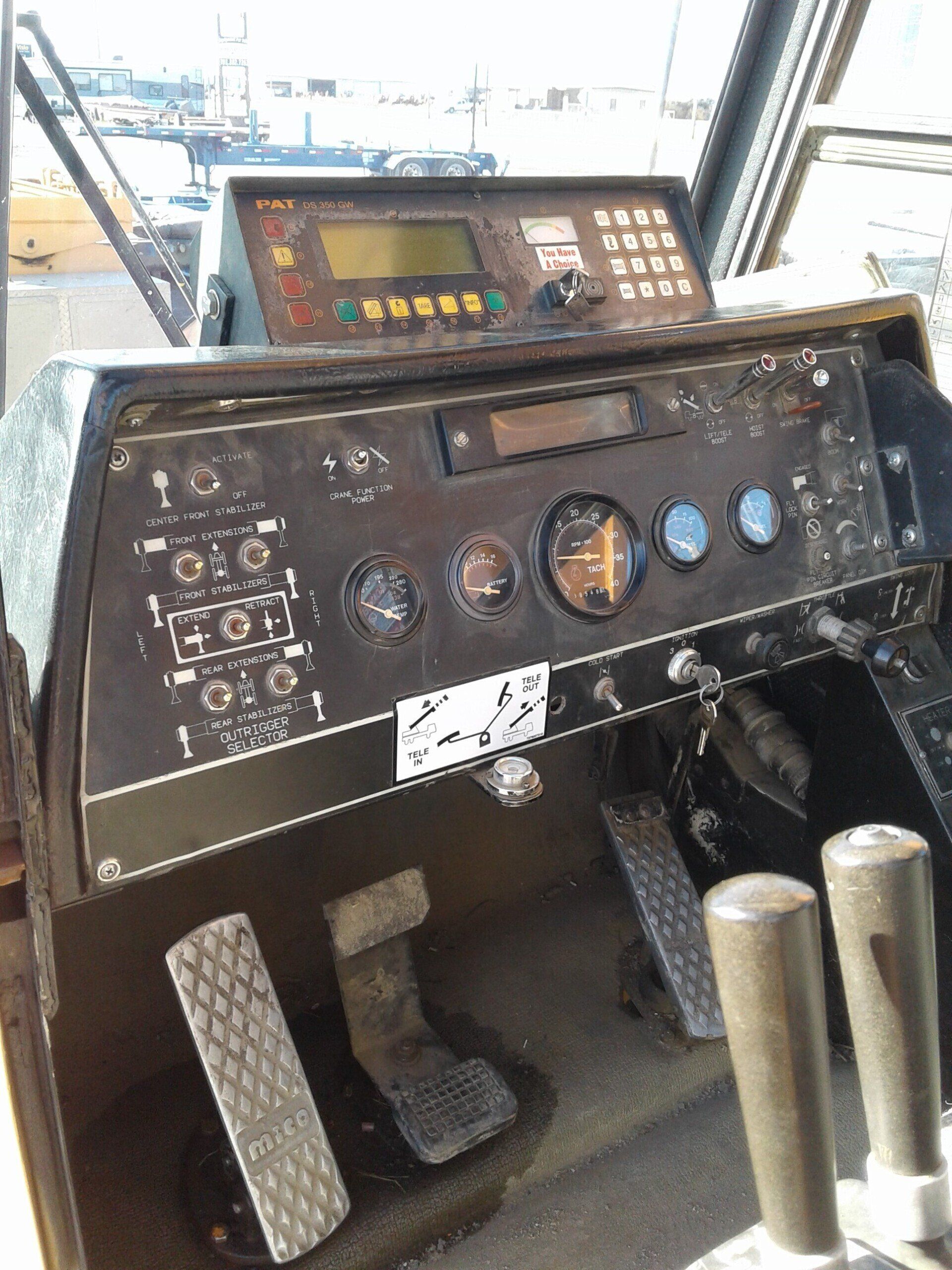 A close up of a dashboard of a vehicle with a lot of buttons and controls.
