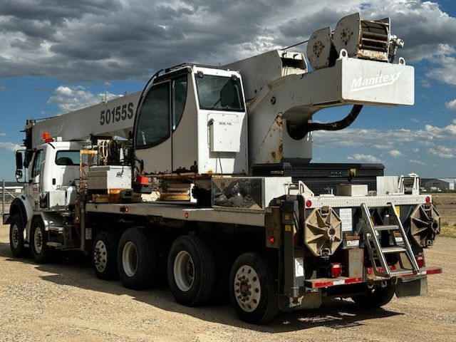 A large crane is on the back of a truck.