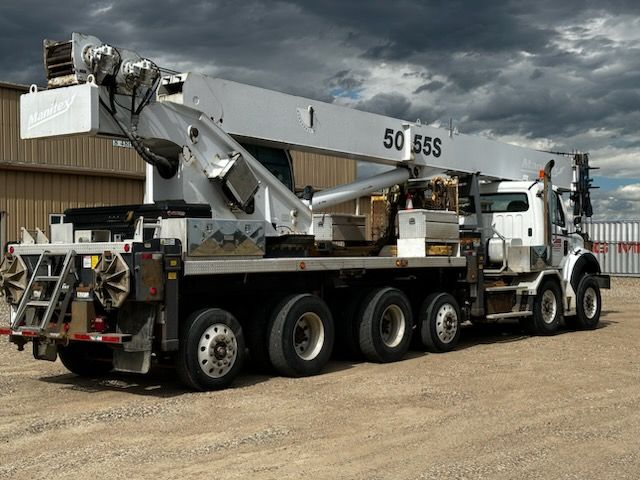 A white truck with a crane attached to it that says 50 sss
