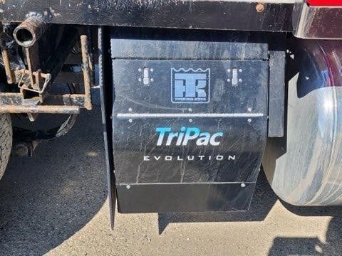 The back of a truck has a tripac evolution sign on it