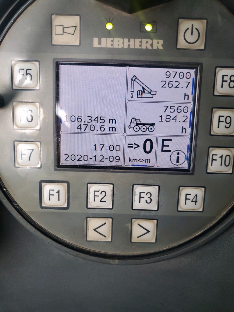 A liebherr dashboard with a screen showing a crane on it