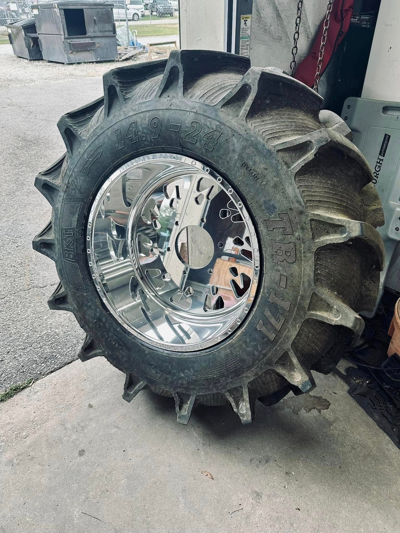 A tire with spikes on it is sitting on the ground.
