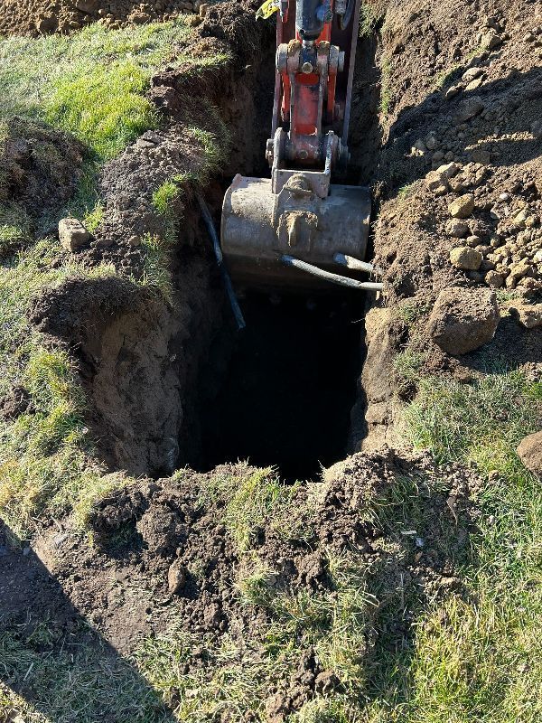 An excavator is digging a hole in the ground.