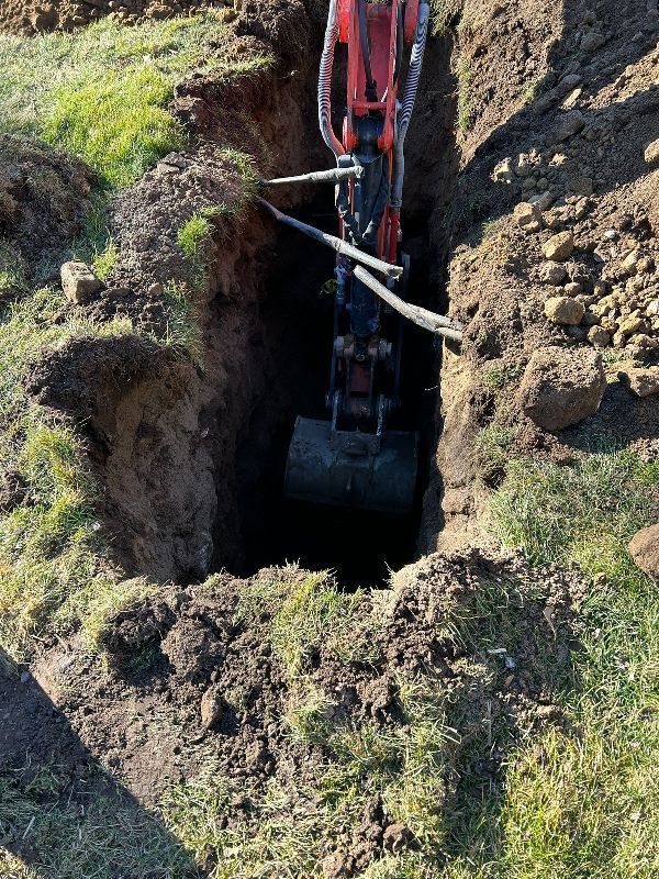 An excavator is digging a hole in the ground.