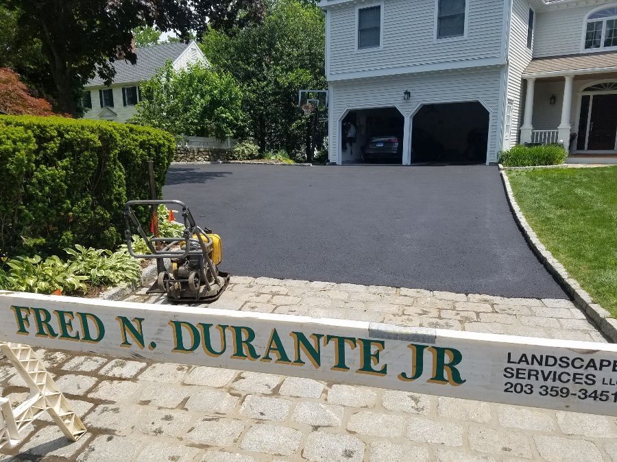 A sign for Fred N. Durante Jr is in front of a house