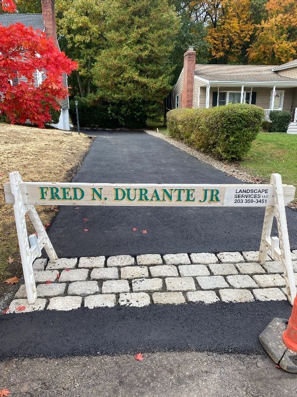 A sign that says fred n. durante jr is on the side of a road.