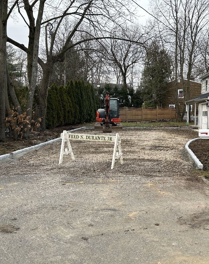 A construction site with a tractor and a fence in the background.